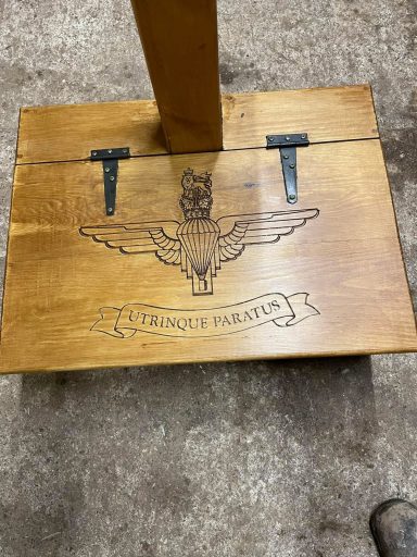 Wooden box with metal hinges, featuring an eagle emblem and the text "French Marine."